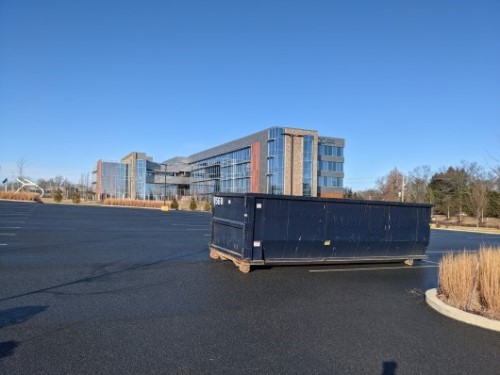 commercial roll off dumpster at office building