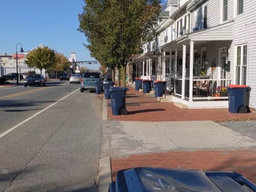 Municipal city street with waste cans on the curbs